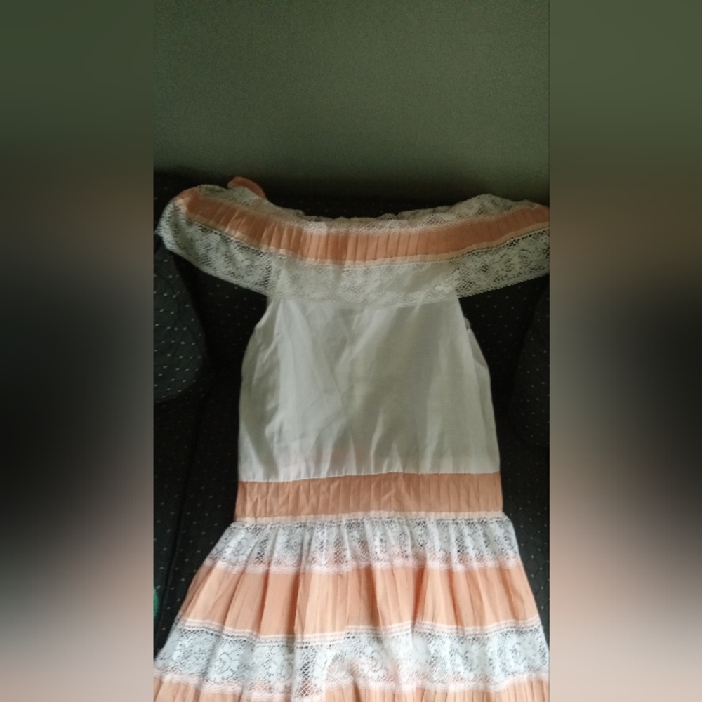 While and Orange dress with a flower trim